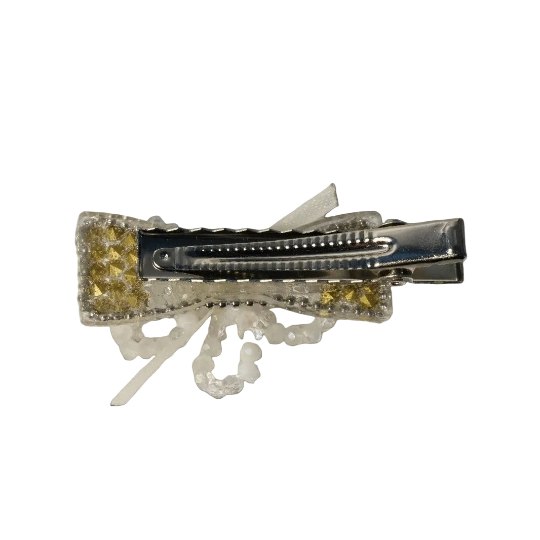 Decorative hair clip with intricate design on a black background
